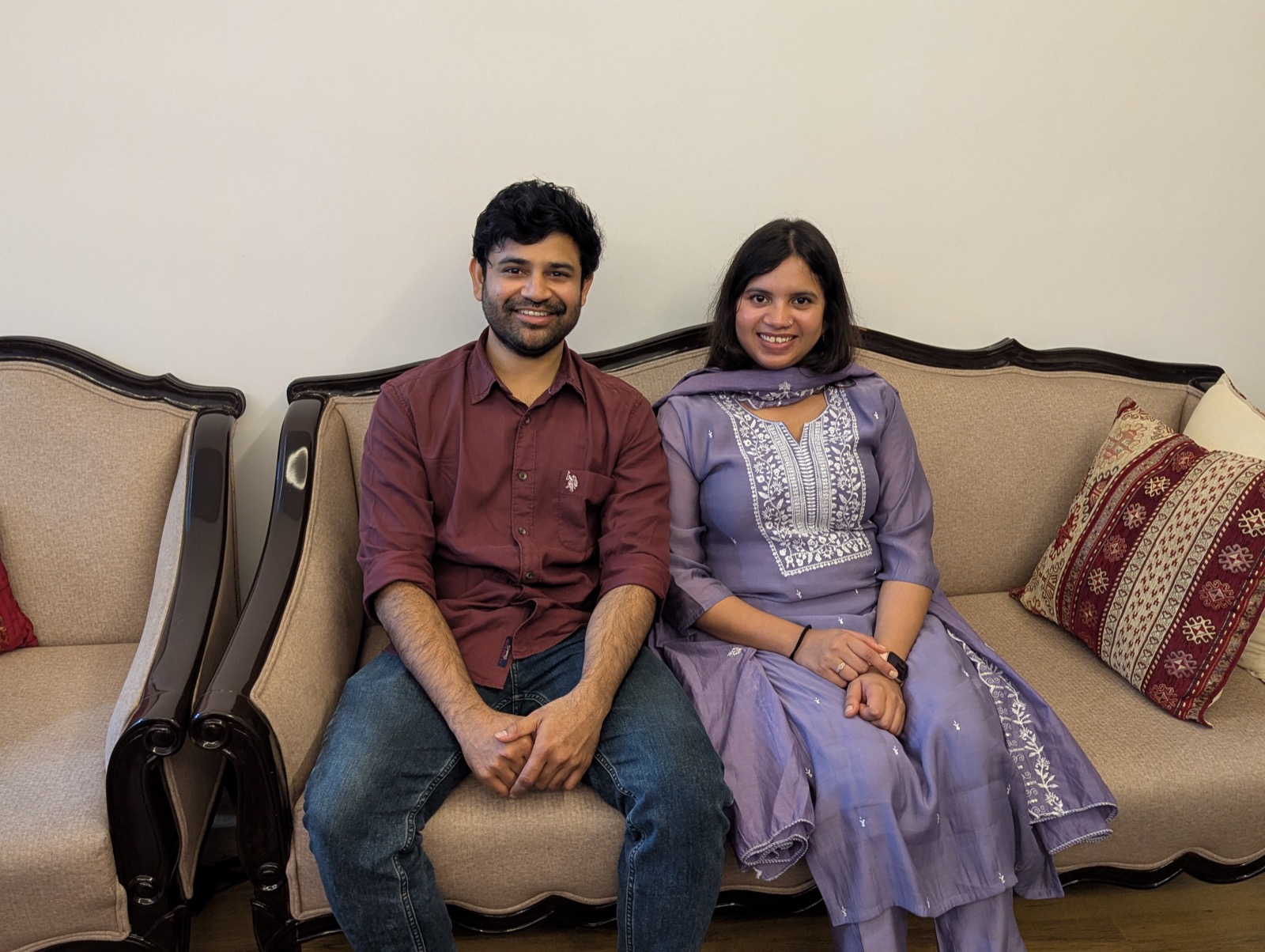 Snigdha and Somnath on a sofa